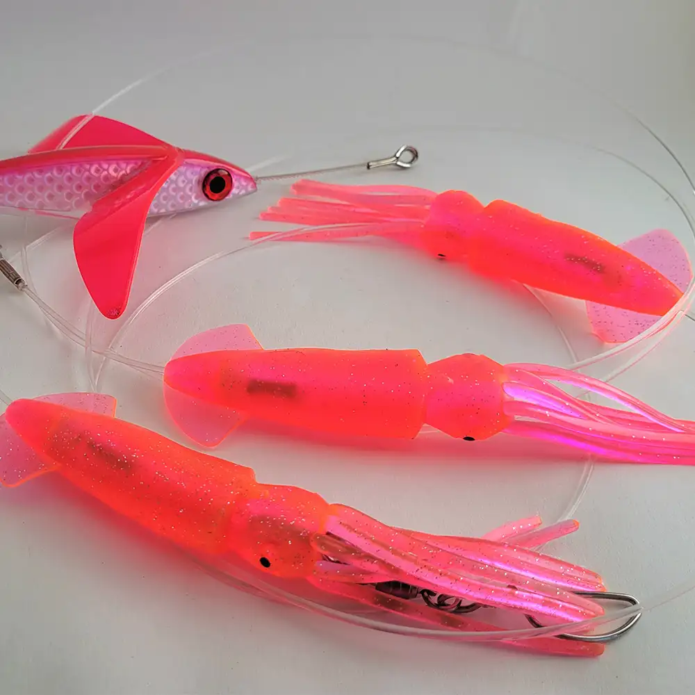Three bright pink hawaiian malolo squids on a daisy chain paired with a bright pink hawaiian malolo bird teaser